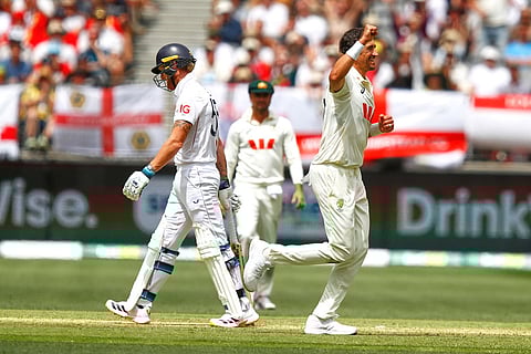 Australia's Mitchell Starc celebrates the wicket of England's captain Ben Stokes, left, on day two of the first Ashes cricket test match between Australia and England in Perth.