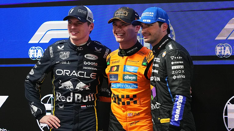From left, second place finisher Red Bull driver Max Verstappen of the Netherlands, first place finisher McLaren driver Lando Norris of Great Britain, and third place finisher Williams driver Carlos Sainz of Spain pose for a photo after a qualifying session - AP/Eric Gay