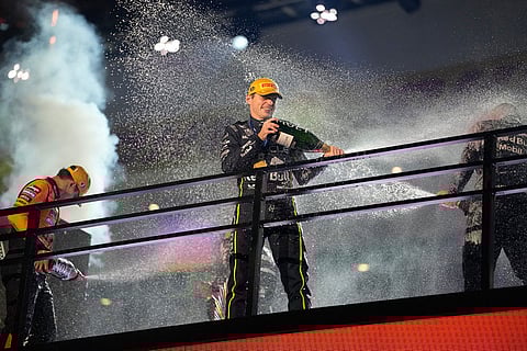 From left, second place finisher McLaren driver Lando Norris of Great Britain, first place finisher Red Bull driver Max Verstappen of the Netherlands, and third place finisher Mercedes driver George Russell of Great Britain celebrate after the Formula One Las Vegas Grand Prix auto race in Las Vegas.