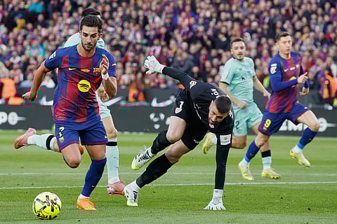 Barcelona's Ferran Torres tries to score by Athletic Bilbao's goalkeeper Unai Simonduring a La Liga soccer match between Barcelona and Athletic in Barcelona, Spain.