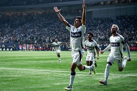 Vancouver Whitecaps' Mathias Laborda (2) celebrates his goal against Los Angeles FC with Ralph Priso (6) and Tristan Blackmon (33) during the first half of the MLS Western Conference semifinal playoff soccer match,  in Vancouver.