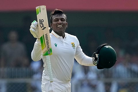 South Africa's Senuran Muthusamy celebrates after scoring a century on the second day of the second cricket test match between India and South Africa in Guwahati.