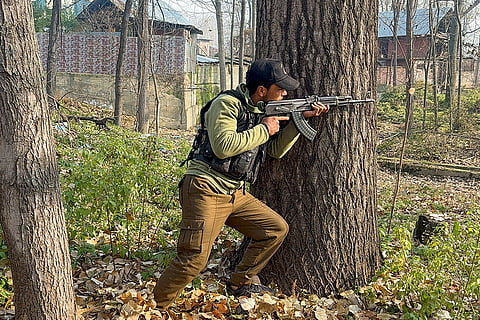 Armed security personnel conduct a cordon and search operation after inputs about the presence of a suspected terrorist, in Kulgam, Jammu and Kashmir.