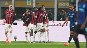 | Photo: AP/Antonio Calanni : AC Milan players celebrate after scoring during the Serie A match against Inter Milan on November 23, 2025.