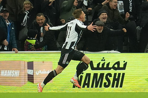 Newcastle's Harvey Barnes runs after scoring during a Premier League soccer match between Newcastle United and Manchester City in Newcastle, England.