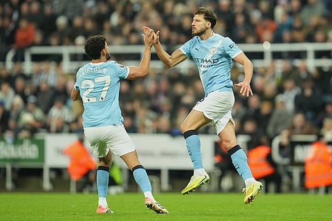 Manchester City's Matheus Nune-, left, and Ruben Dias celebrate after scoring during a Premier League soccer match between Newcastle United and Manchester City in Newcastle, England.