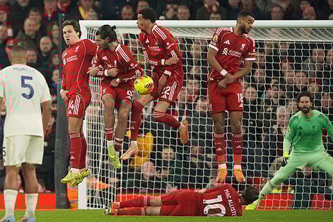 Liverpool players go up to block a free kick during the English Premier League soccer match between Liverpool and Nottingham Forest in Liverpool, England.