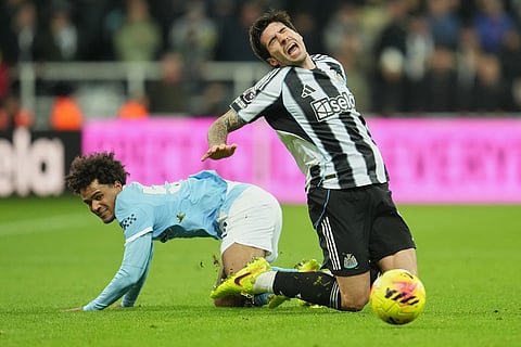 Manchester City's Oscar Bobb tackles Newcastle's Sandro Tonali during a Premier League soccer match between Newcastle United and Manchester City in Newcastle, England.
