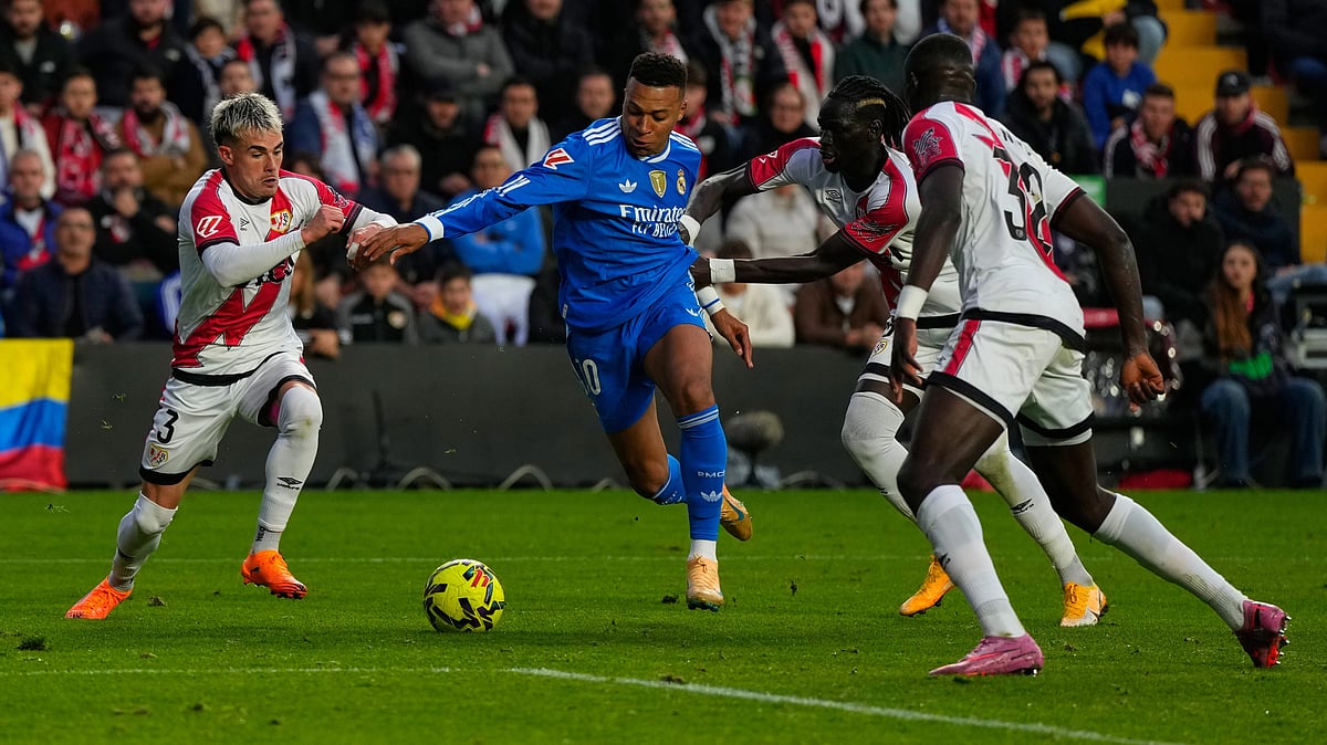 Rayo Vallecano's Pep Chavarria and teammates stop Real Madrid's Kylian Mbappe from scoring during a Spanish La Liga match on November 9, 2025. - | Photo: AP/Manu Fernandez