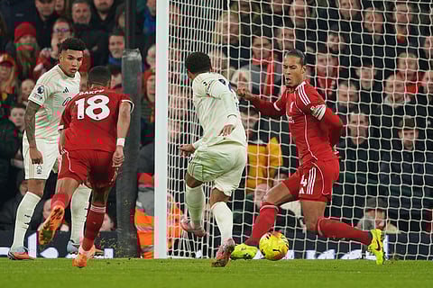 Nottingham Forest's Morgan Gibbs-White, centre, scores his side's third goal during the English Premier League soccer match between Liverpool and Nottingham Forest in Liverpool, England.