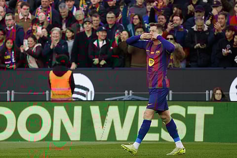 Barcelona's Robert Lewandowski reacts after scoring during a La Liga soccer match between Barcelona and Athletic in Barcelona, Spain.