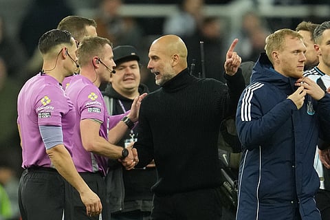 Manchester City's head coach Pep Guardiola argues with referees after a Premier League soccer match between Newcastle United and Manchester City in Newcastle, England.