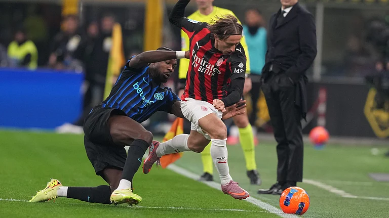 Inter Milan's Marcus Thuram tackles AC Milan's Luka Modric during the Serie A match on November 23, 2025. - | Photo: AP/Antonio Calanni