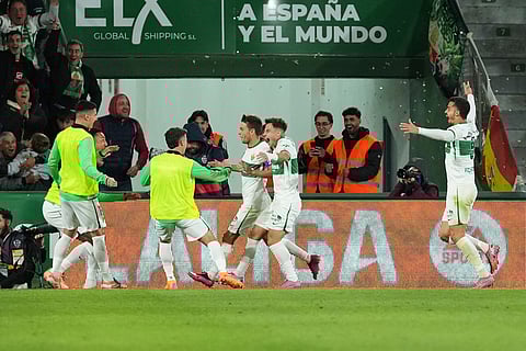 Elche's Aleix Febas, centre left, celebrates after scoring the opening goal during the Spanish La Liga soccer match between Elche and Real Madrid in Elche, Spain.