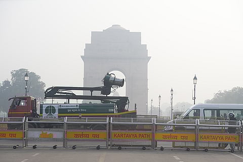 An NDMC vehicle mounted with an anti-smog gun moves past India Gate, in New Delhi.
