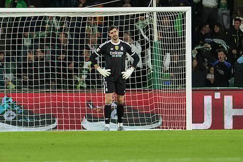 Real Madrid's goalkeeper Thibaut Courtois reacts after Elche's Alvaro Rodrigue scored his side's second goal during the Spanish La Liga soccer match between Elche and Real Madrid in Elche, Spain.
