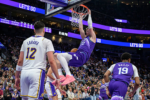 Utah Jazz forward Kyle Filipowski, center, dunks the ball during the second half of an NBA basketball game against the Los Angeles Lakers in Salt Lake City.