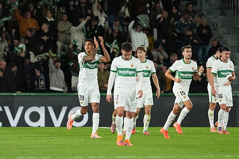 Elche's Alvaro Rodriguez, left, celebrates with teammates after scoring his side's second goal during the Spanish La Liga soccer match between Elche and Real Madrid in Elche, Spain.