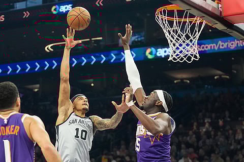 San Antonio Spurs forward Jeremy Sochan (10) shoots over Phoenix Suns center Mark Williams (15) during the first half of an NBA basketball game in Phoenix.