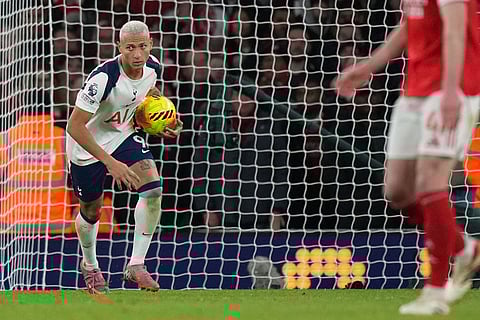 Tottenham's Richarlison brings the ball back to the center after scoring during a Premier League soccer match between Arsenal and Tottenham in London.