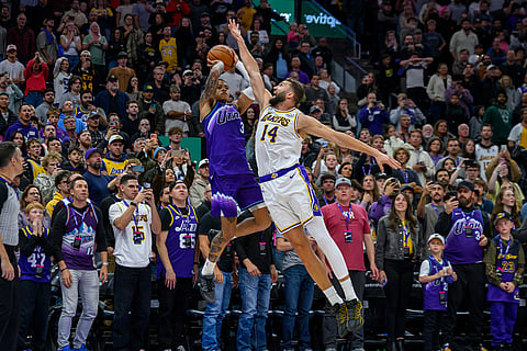 Utah Jazz guard Keyonte George (3) takes the final shot of the game defended by Los Angeles Lakers forward Maxi Kleber (14) as the Jazz attempted to tie the game and send to overtime during the second half of an NBA basketball game in Salt Lake City.