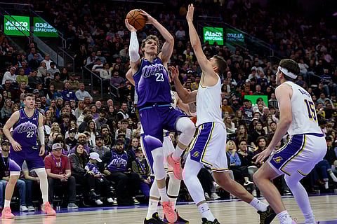 Utah Jazz forward Lauri Markkanen (23) shoots the ball guarded by Los Angeles Lakers forward Maxi Kleber, center right, during the second half of an NBA basketball game in Salt Lake City.