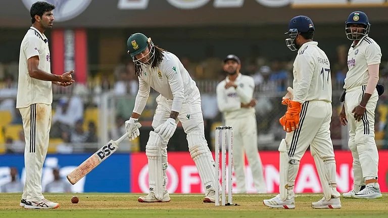 South Africa's Tony de Zorzi waits as India's players discuss for an appeal on the first day of the second cricket test match between India and South Africa in Guwahati. - | Photo: AP/Anupam Nath