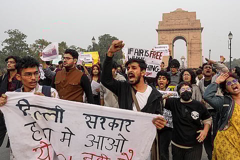 People raise slogans during a protest against worsening air quality in the national capital, at the India Gate, in New Delhi.