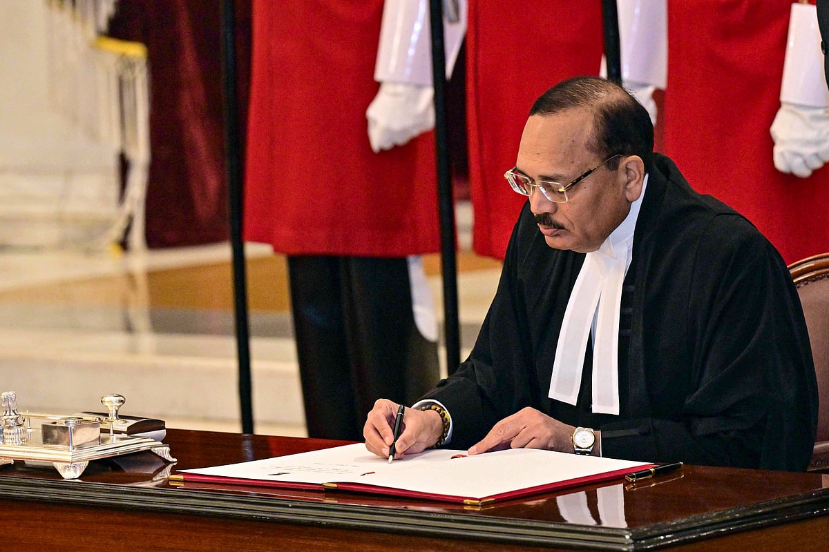 Nov. 24, 2025, Justice Surya Kant signs the documents after taking oath as the 53rd Chief Justice of India (CJI), at Rashtrapati Bhavan in New Delhi - PTI
