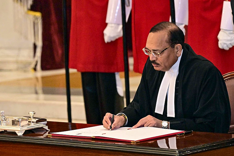 Nov. 24, 2025, Justice Surya Kant signs the documents after taking oath as the 53rd Chief Justice of India (CJI), at Rashtrapati Bhavan in New Delhi - PTI