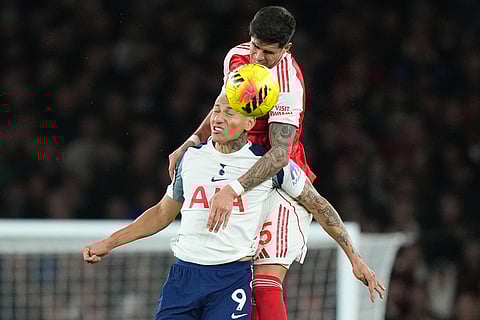 Arsenal's Piero Hincapie, top, and Tottenham's Richarlison jump for the ball during a Premier League soccer match between Arsenal and Tottenham in London.