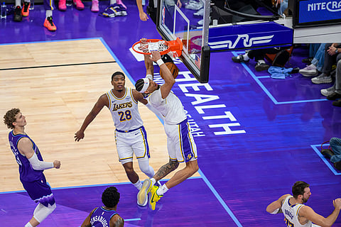 Los Angeles Lakers center Jaxson Hayes, center, dunks the ball during the first half of an NBA basketball game against the Utah Jazz in Salt Lake City.