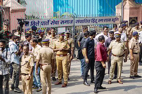 Police personnel and media representatives gather outside the Pawan Hans Crematorium, in Mumbai. Bollywood's beloved star Dharmendra has died at 89, according to police. 