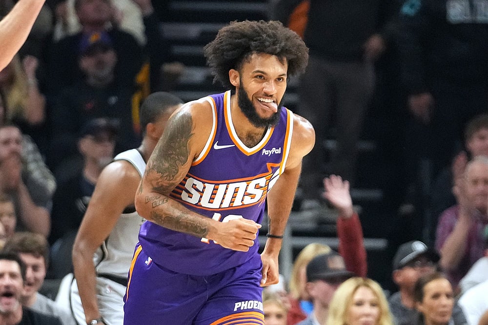 Phoenix Suns forward Isaiah Livers smiles after hitting a three-pointer against the San Antonio Spurs during the first half of an NBA basketball game in Phoenix.
