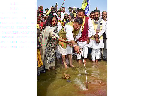 AAP leader Sanjay Singh with his wife Anita Singh performs rituals near the Ganga river during the 'Rozgar Do-Samajik Nyay Do' padyatra, in Prayagraj.
