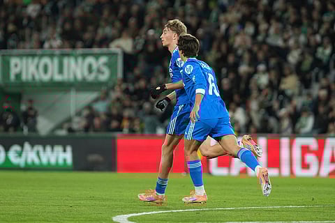 Real Madrid's Dean Huijsen, left, celebrates with Gonzalo Garcia after scoring his side's first goal during the Spanish La Liga soccer match between Elche and Real Madrid in Elche, Spain.