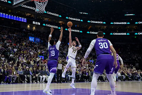 Los Angeles Lakers guard Luka Doncic (77) shoots the ball over Utah Jazz guard Ace Bailey (19) during the first half of an NBA basketball game in Salt Lake City.