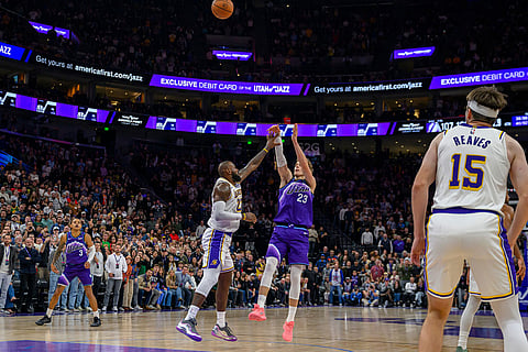 Utah Jazz forward Lauri Markkanen (23) shoots the ball over Los Angeles Lakers forward LeBron James, center left, during the second half of an NBA basketball game in Salt Lake City.