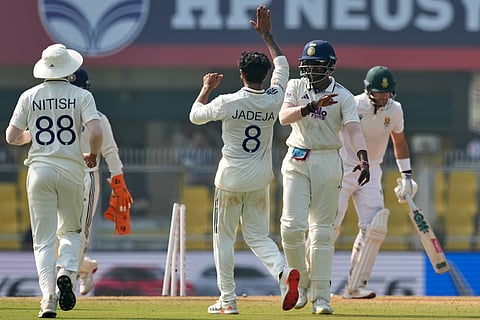 India's Ravindra Jadeja, centre, celebrates with teammates after the dismissal of South Africa's Aiden Markram on the fourth day of the second cricket test match between India and South Africa in Guwahati.