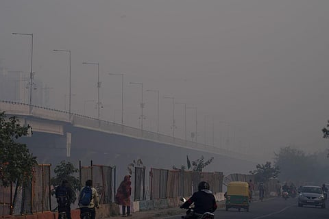 Vehicles ply on a road amid smog as air quality remains in the 'severe' category, in New Delhi.