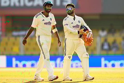 India's captain Rishab Pant, right, and India's Jasprit Bumrah walk off the field after South Africa declared second innings on the fourth day of the second cricket test match between India and South Africa in Guwahati.