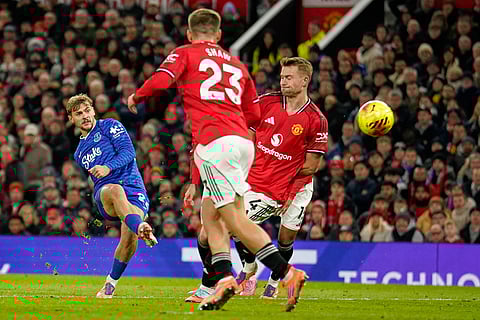 Everton's Kiernan Dewsbury-Hall, left, scores the opening goal during the English Premier League soccer match between Manchester United and Everton in Manchester, England.