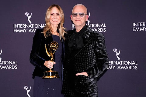 Dana Walden, co-chairman of Disney Entertainment and winner of the Founders Award, and presenter Ryan Murphy, right, appear in the press room during the 53rd International Emmy Awards at the New York Hilton Midtown in New York. 