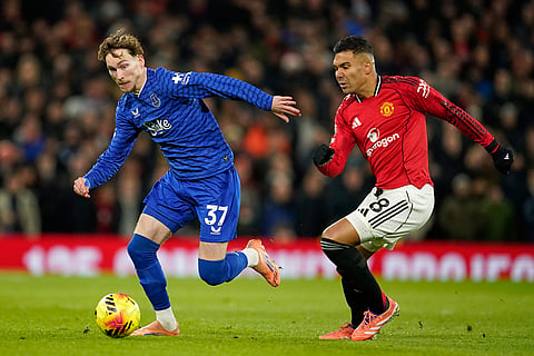 Everton's James Garner, left, is challenged by Manchester United's Casemiro during the English Premier League soccer match between Manchester United and Everton in Manchester, England.