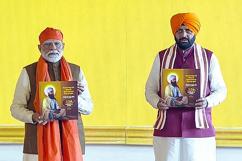 Prime Minister Narendra Modi with Haryana Chief Minister Nayab Singh Saini during a programme organised to mark the 350th martyrdom anniversary of Guru Tegh Bahadur, in Kurukshetra. 