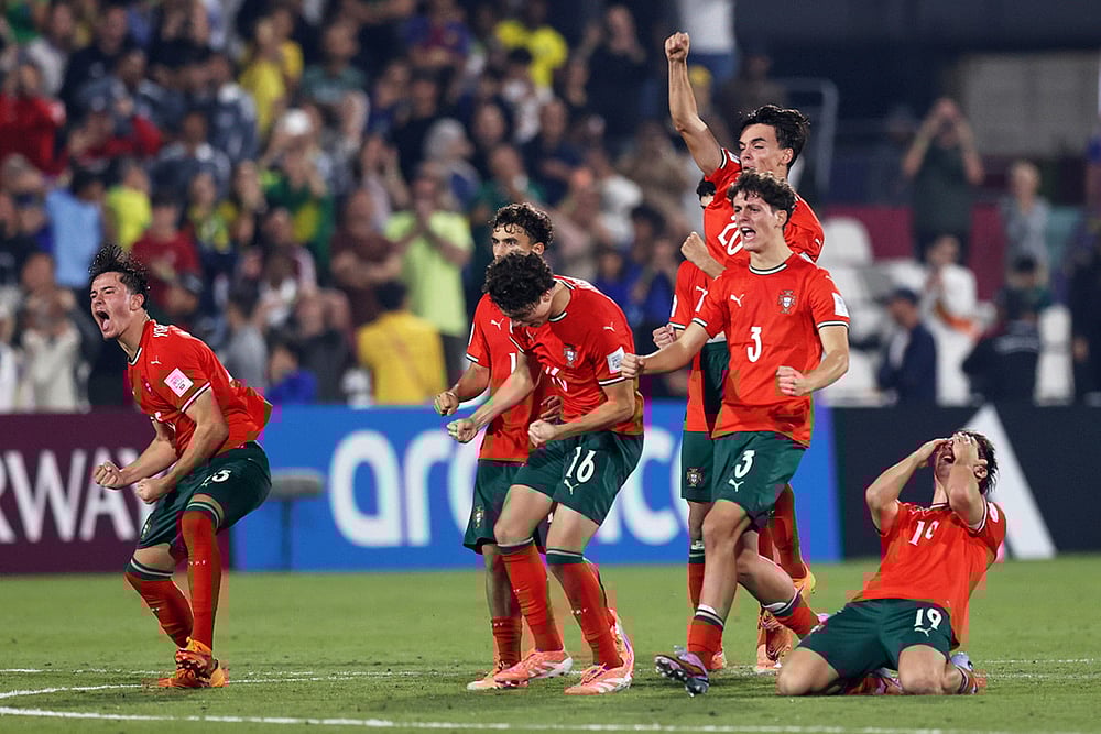 Portugal players celebrate their victory after beating Brazil in a penalty shootout during the FIFA U17 World Cup semifinal soccer match in Doha, Qatar. - | Photo: AP/Hussein Sayed