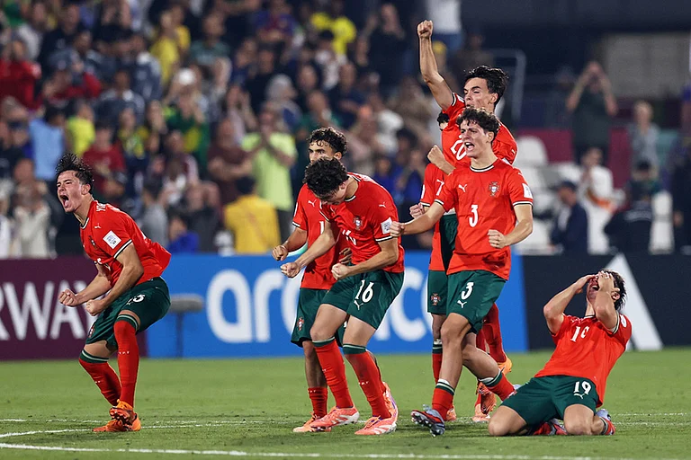 Portugal players celebrate their victory after beating Brazil in a penalty shootout during the FIFA U17 World Cup semifinal soccer match in Doha, Qatar. - | Photo: AP/Hussein Sayed