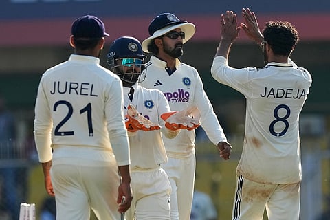 India's Ravindra Jadeja, right, celebrates with teammates after the dismissal of South Africa's Tristan Stubbs on the fourth day of the second cricket test match between India and South Africa in Guwahati.
