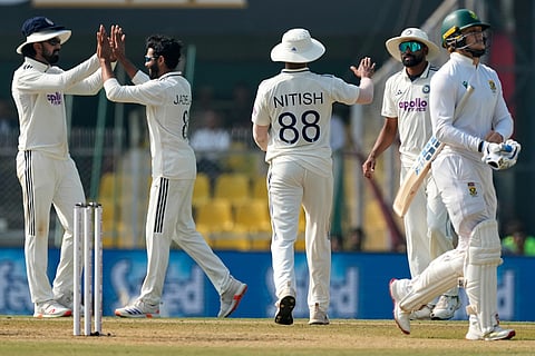 India's players celebrate the dismissal of South Africa's Ryan Rickelton, right, on the fourth day of the second cricket test match between India and South Africa in Guwahati.