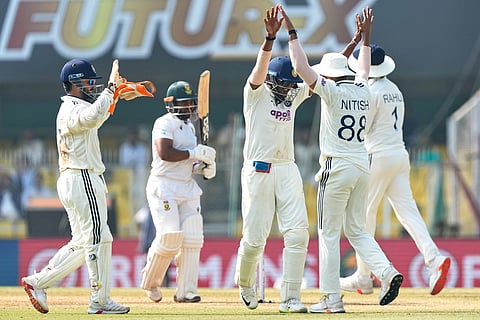 India's players celebrate the dismissal of South Africa's captain Temba Bavuma, second left, on the fourth day of the second cricket test match between India and South Africa in Guwahati.
